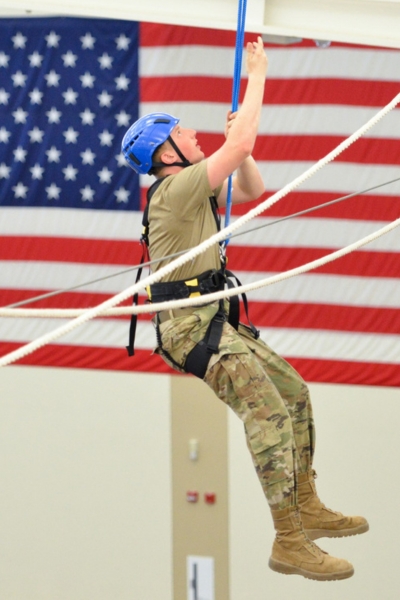 Cadet in Air Force ROTC, which also commissions into Space Force, climbs on ϲ's ropes course.