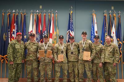 ϲ cadets receive award plaques at an Army ROTC pistol competition.