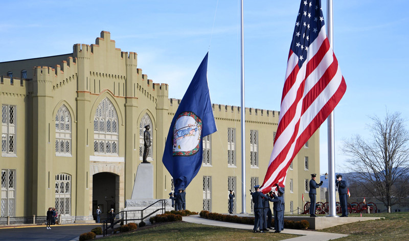 ϲ cadets raise the Virginia and US flags before a parade