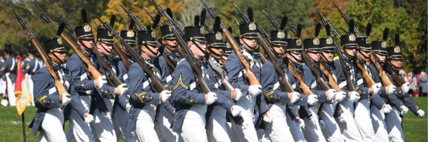Cadets march with rifles on shoulders during a fall parade at ϲ.