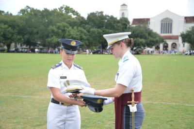Kasey Meredith ’22 and Kathryn Christmas, Citadel regimental commander, exchange momento covers at the Citadel.—ϲ Photo by Eric Moore.