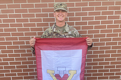 Cadet Carter Hugate '24 holds ϲ flag at Army Airborne School