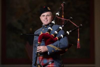 Dakota Birdsong ’24, a cadet at ϲ, poses with his bagpipe and ϲ Pipe Band uniform, which includes a tartan.
